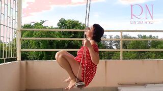 Charming Housewife Enjoys a Playful Swing in the Nude - A Retro Pin-Up Delight