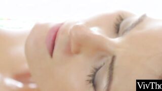 Beautiful lesbian oils up lover and fingers her smooth pussy