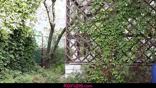 Watch this petite redhead tease and finger her shaved pussy in the garden