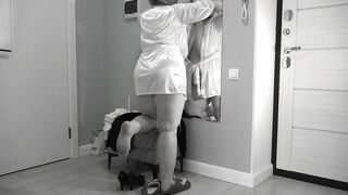A mature, fat milf with big, saggy tits is changing clothes in front of the mirror.